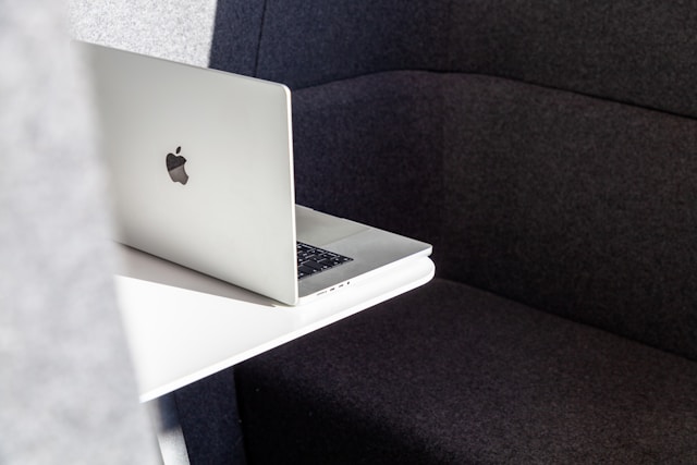 A laptop computer sitting on top of a white table